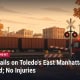 Illustration of a railroad crossing with lowered gates, freight cars and a fire engine, with the headline: Train Derails on Toledo's East Manhattan Boulevard; No Injuries